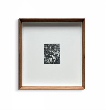 small framed picture in black and white of the rock detail of a mountain