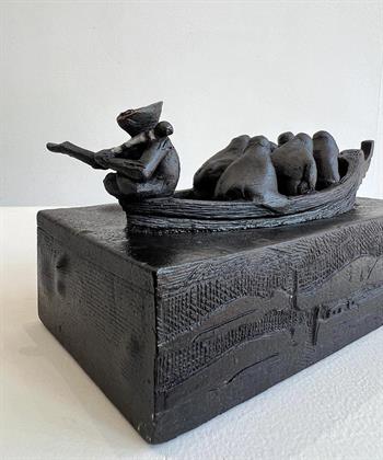 small clay sculpture depticting Xhosa men in a boat